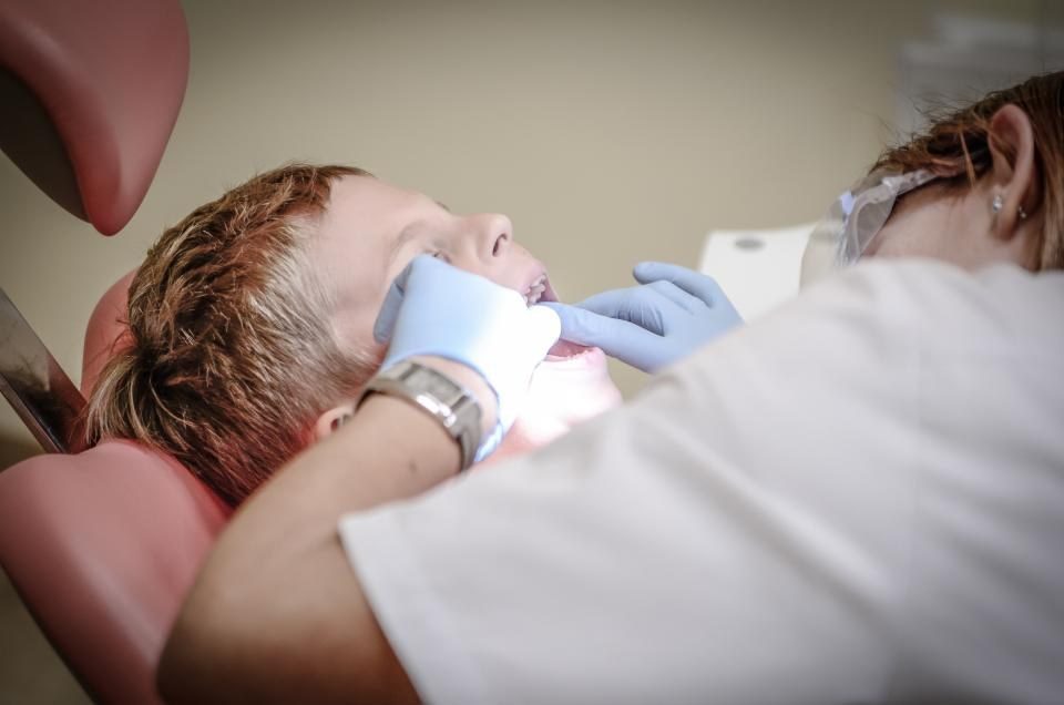 Dentist checking a young patient's teeth